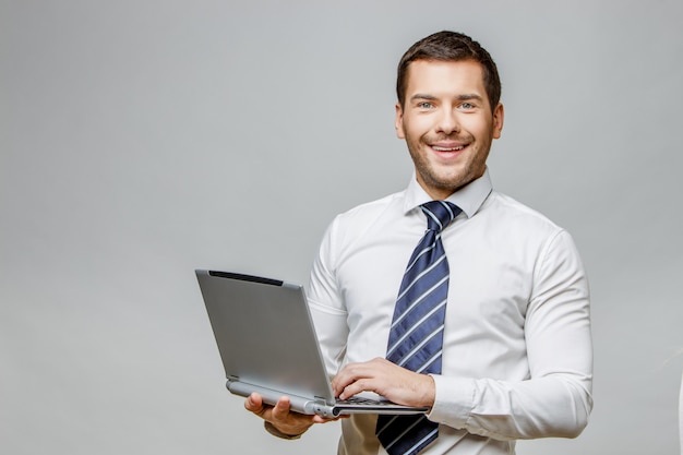 Handsome stylish businessman on grey background