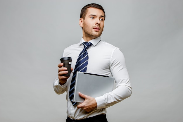 Handsome stylish businessman on grey background