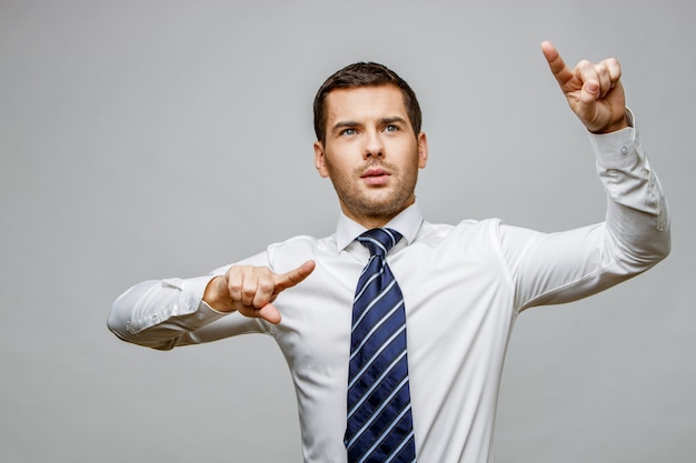 Handsome stylish businessman on grey background