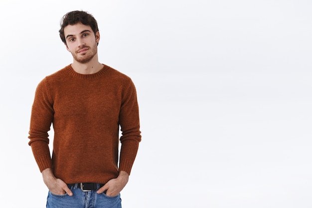 Handsome stylish european male in sweatshirt, hold hands in pockets