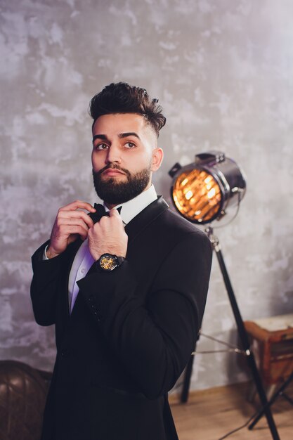 handsome stylish man in elegant black suit.