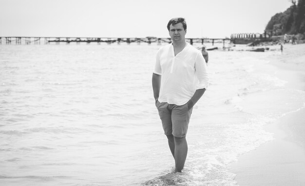 handsome stylish man standing on the sea