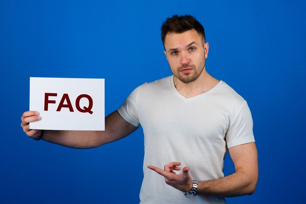 Handsome stylish man with a faq paper sign