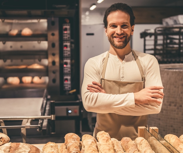 Handsome supermarket worker is looking at camera.