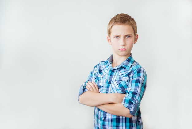 Handsome teen boy standing with arms crossed