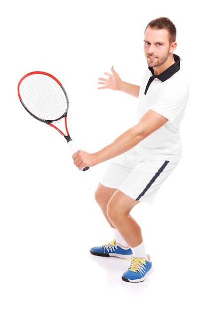 a handsome tennis player with a racket over white background