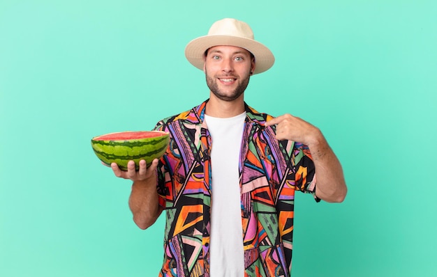 Handsome traveler man feeling happy and pointing to self with an excited and holding a watermelon. holidays concept