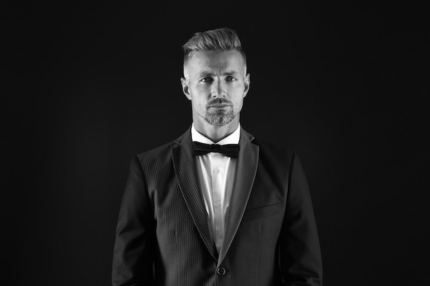 Handsome tuxedo man formal and business fashion groomed male on special event its wedding day stylish art director real esthete in all details being real gentleman wear bow tie