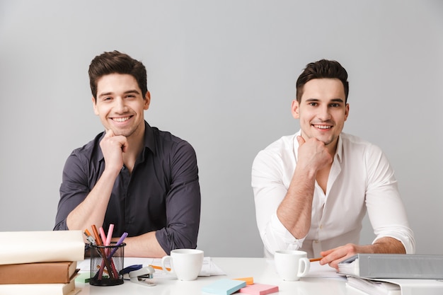 Handsome two cheerful young men colleagues