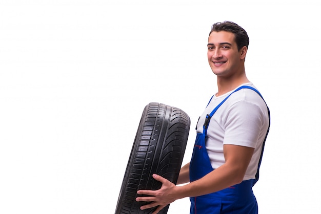 Handsome tyre repairman isolated on white