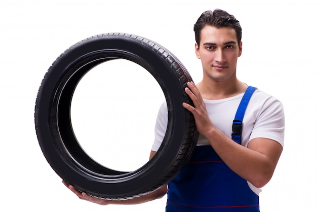 Handsome tyre repairman isolated on white