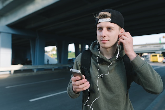 Handsome urban boy listening to music