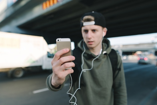 Handsome urban boy listening to music