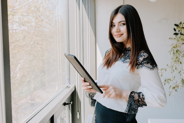 Handsome woman with tablet Modern business admin