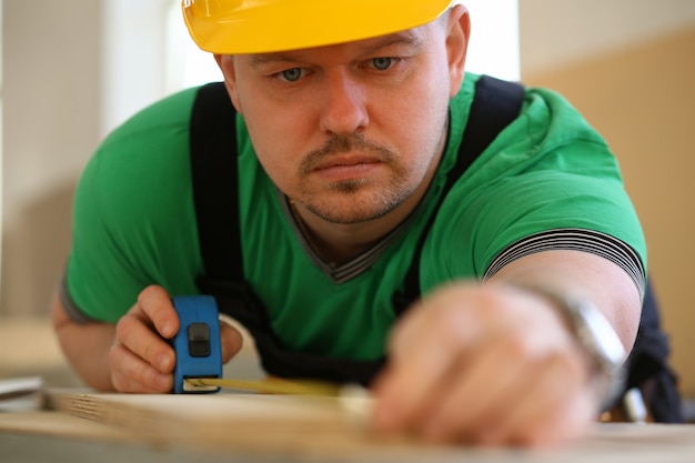 Handsome worker measuring. Manual