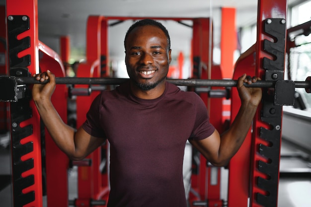 Handsome young African American man working out at the gym