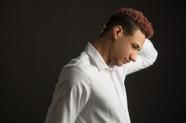 handsome young african man on black background