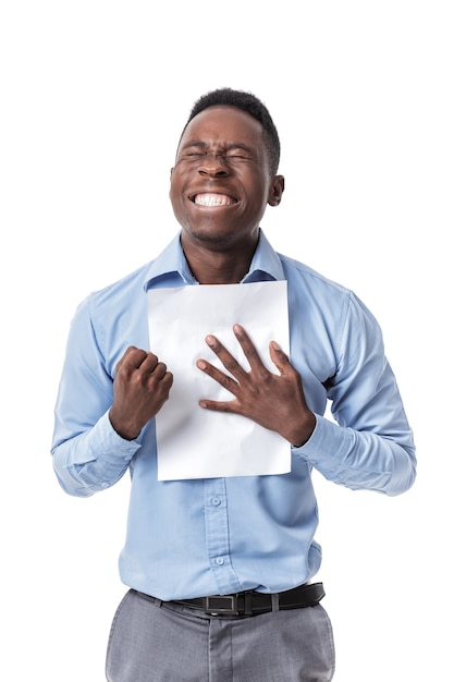 Handsome young Afro American businessman  keeping fist up and document screaming with happiness on white