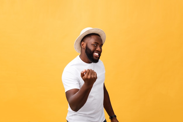 Handsome young Afro-American man employee feeling excited, gesturing actively, keeping fists clenched, exclaiming joyfully with mouth wide opened