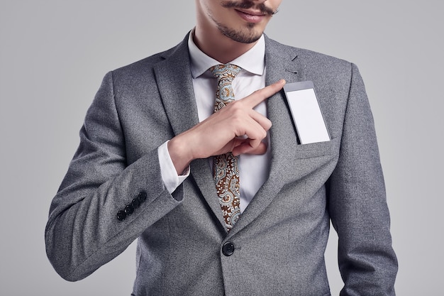 Handsome young arabic businessman with mustache in fashion gray suit