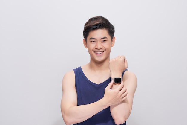 Handsome young asian man Watching on his watch in white background