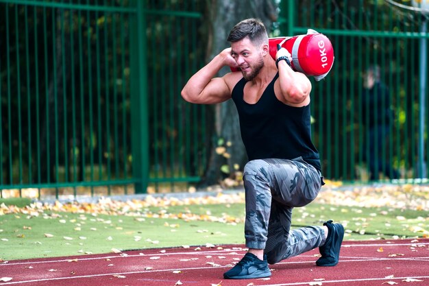 Handsome young athlete working out on a running track