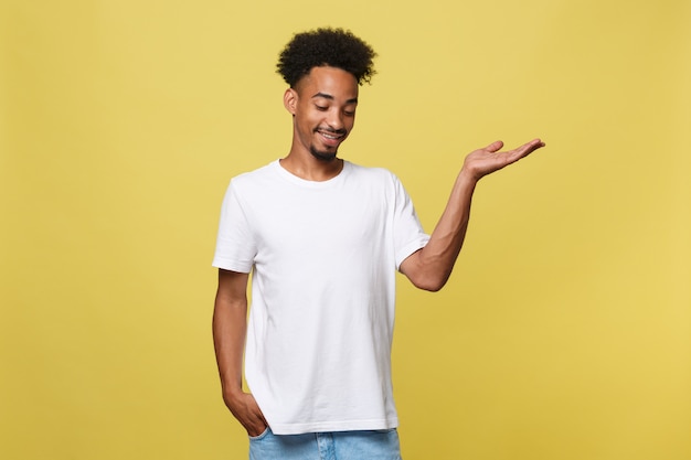 handsome young black man holding his hand up to show present sell product