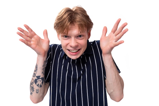 A handsome young blond man in a blue polo tells a funny story