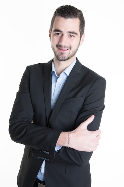 Handsome young businessman standing arms crossed smiling