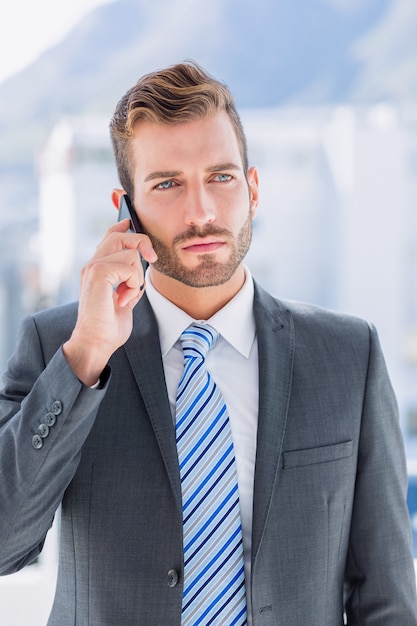 Handsome young businessman using mobile phone