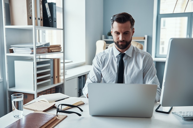 Handsome young businessman working on the desk