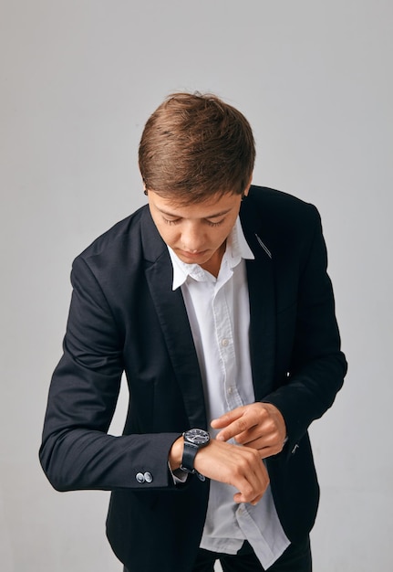 Handsome Young businesswoman looking at her watch in a stylish jacket