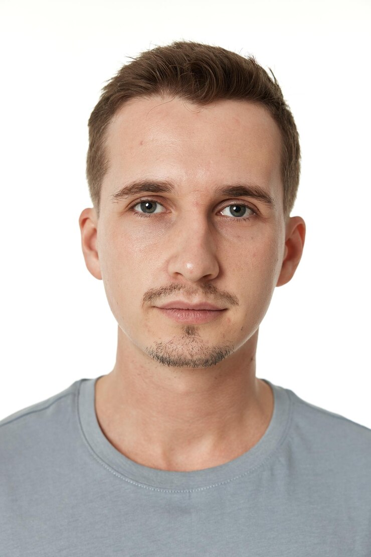 Handsome young calm man on white background