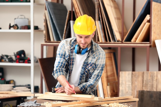 Handsome young carpenter in workshop