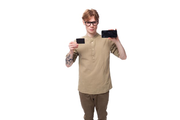 Handsome young caucasian male promoter with red hair and a tattoo on his arm dressed in a khaki