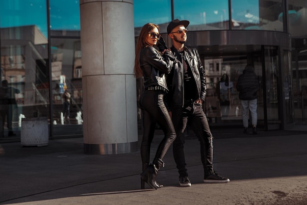 Handsome young couple posing in the street daytime