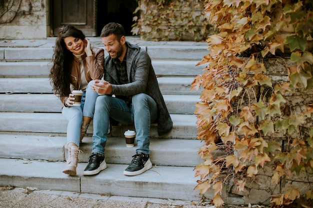 Young romantic wedding couple posing on a bench outdoors Stock Photo - Alamy