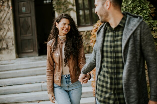 Handsome young couple walking in autumn park