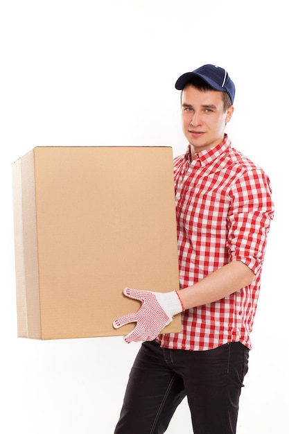 Handsome young courier with brown box