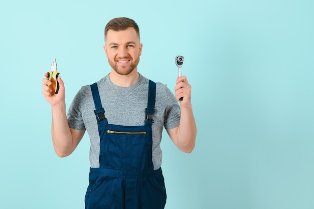 Handsome young craftsman over isolated blue background