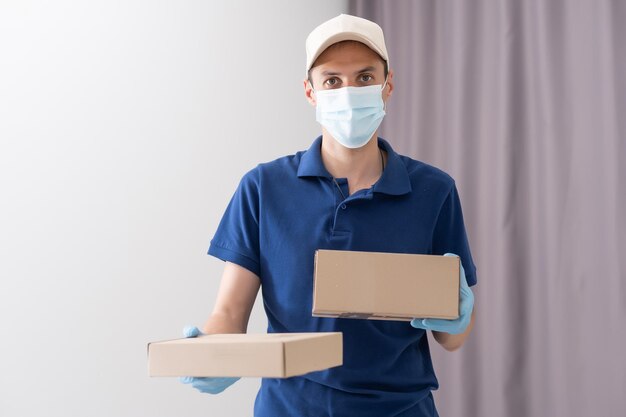 handsome young delivery man portrait on white.