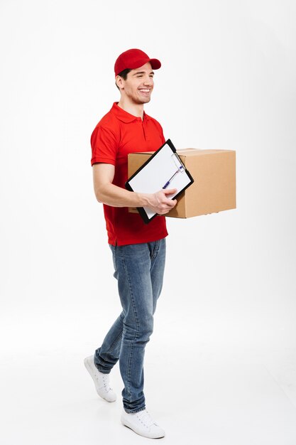 Handsome young delivery man with parcel post box