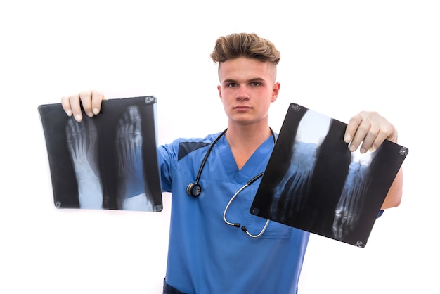 Handsome and young doctor holding foot x-ray of a patient . Medical help concept