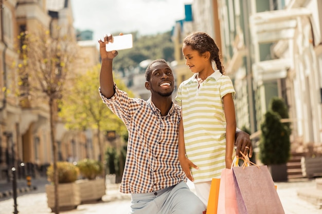 Handsome young father doing selfie photo during walk