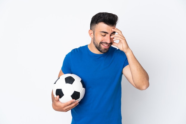 Handsome young football player man over isolated wall laughing