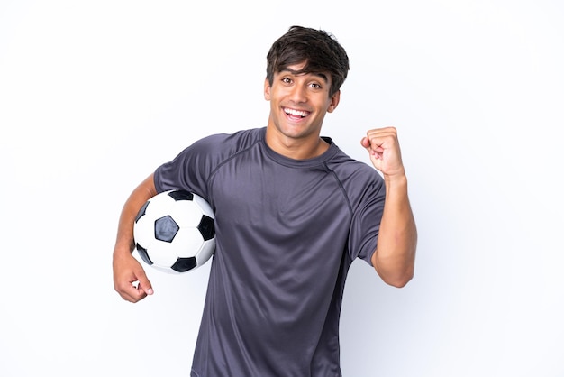 Handsome young football player man isolated on white background celebrating a victory in winner position