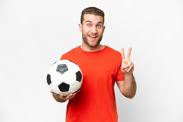 Handsome young football player man over isolated white background smiling and showing victory sign