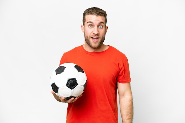 Handsome young football player man over isolated white background with surprise facial expression