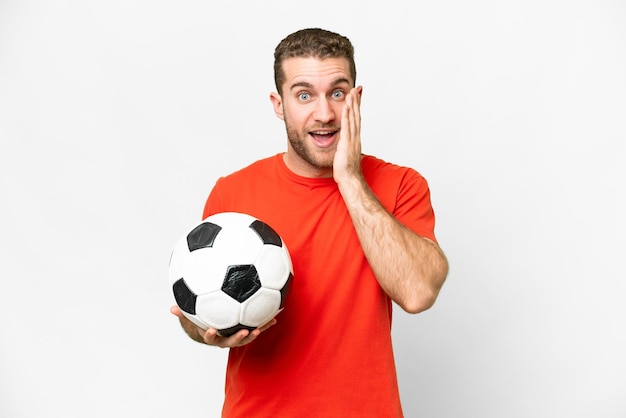 Handsome young football player man over isolated white background with surprise and shocked facial expression