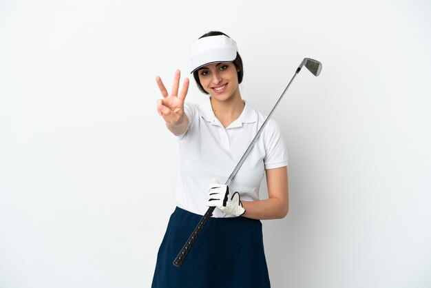 Handsome young golfer player woman isolated on white background happy and counting three with fingers